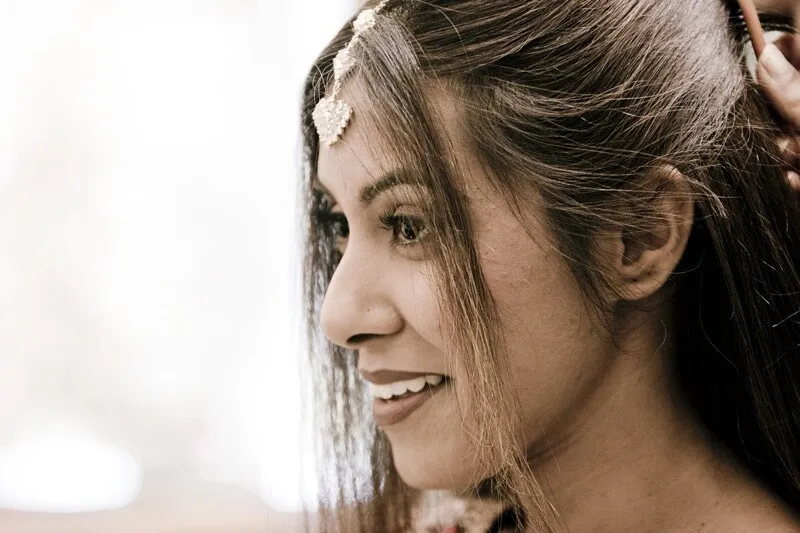 Bridal side profile with wedding hairstyle and traditional makeup
